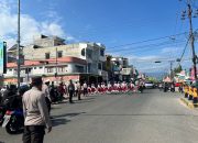 Wakili Kapolsek, Kanit 2 Binmas Polsek Wonomulyo Hadiri Gerak Jalan Tingkat SD dan SMP se-Kecamatan Wonomulyo dalam Rangka HUT RI ke-80